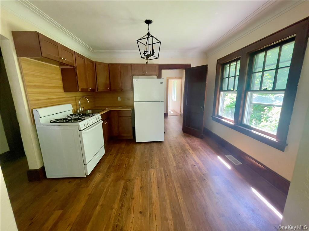 4 Old Turnpike Road Bloomingburg, NY 12721 - Photo 11 of 27 Kitchen with dark hardwood / wood-style flooring, crown molding, sink, white appliances, and pendant lighting
