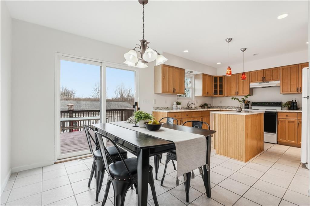 3699 Mitchell Road New Castle, PA 16105 - Photo 6 of 14 a kitchen with stainless steel appliances granite countertop a stove a sink a stove a dining table and chairs