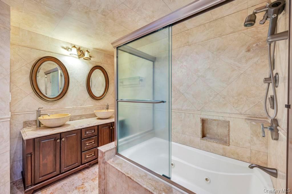 2585 Oceanside Road Oceanside, NY 11572 - Photo 11 of 30 a bathroom with a sink and a mirror