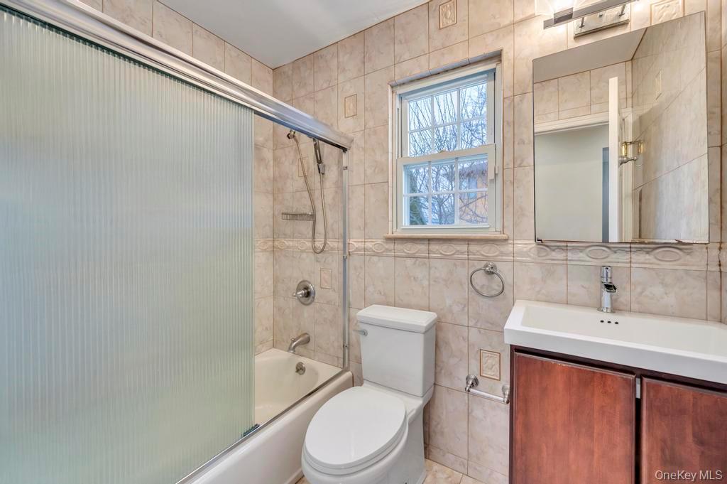 2585 Oceanside Road Oceanside, NY 11572 - Photo 16 of 30 a bathroom with a sink a toilet and shower