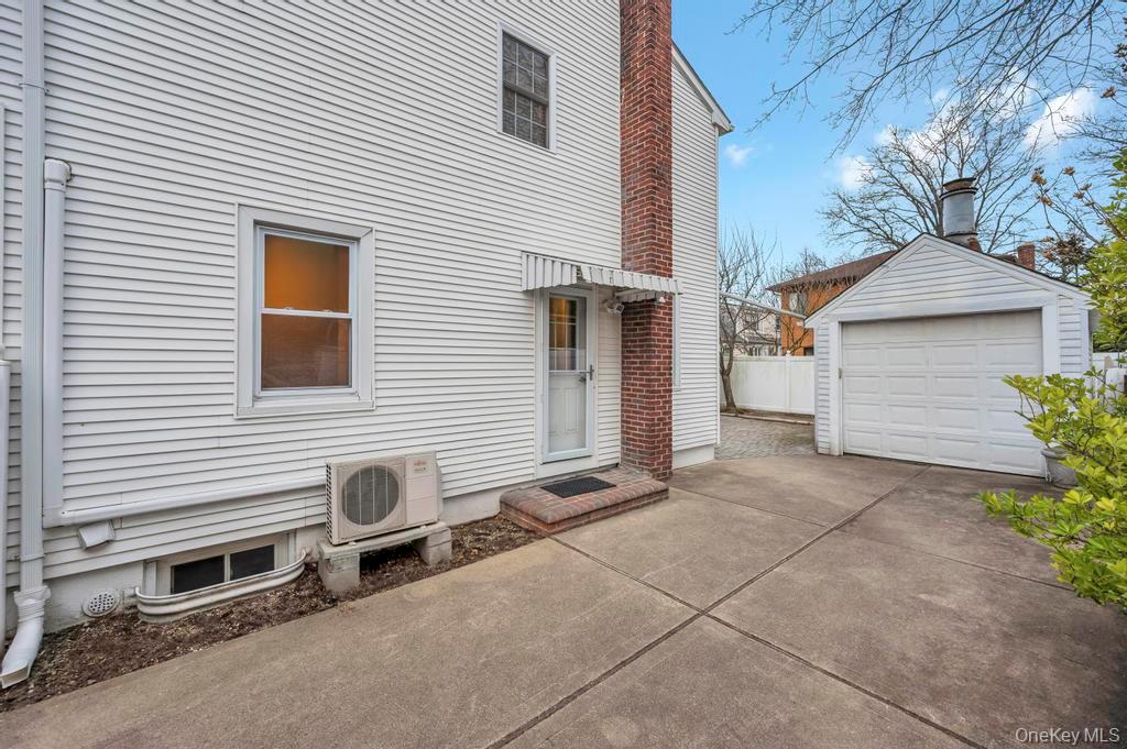 2585 Oceanside Road Oceanside, NY 11572 - Photo 17 of 30 a backyard of a house with plants and garage