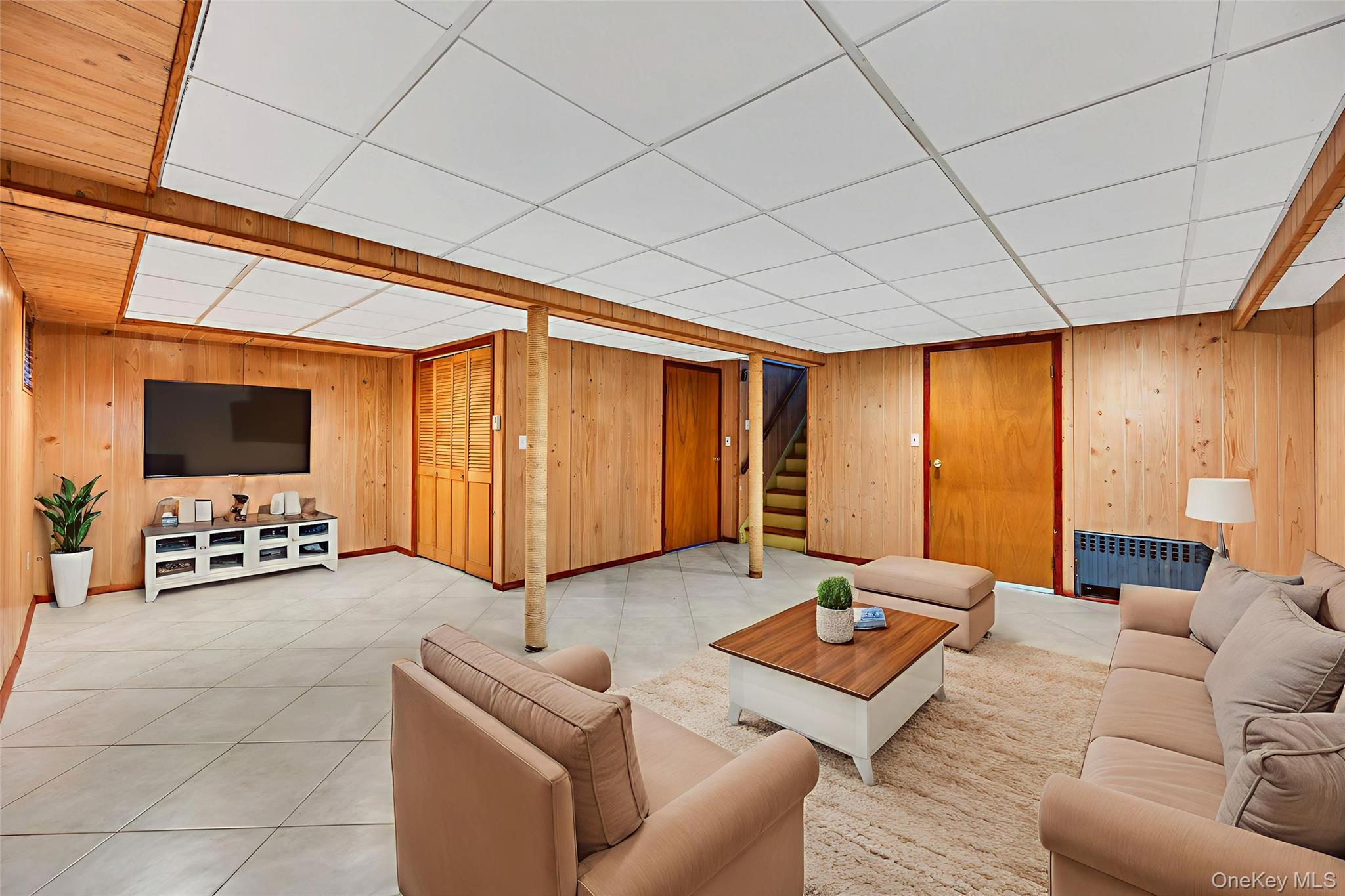 2585 Oceanside Road Oceanside, NY 11572 - Photo 19 of 30 a living room with furniture and a flat screen tv