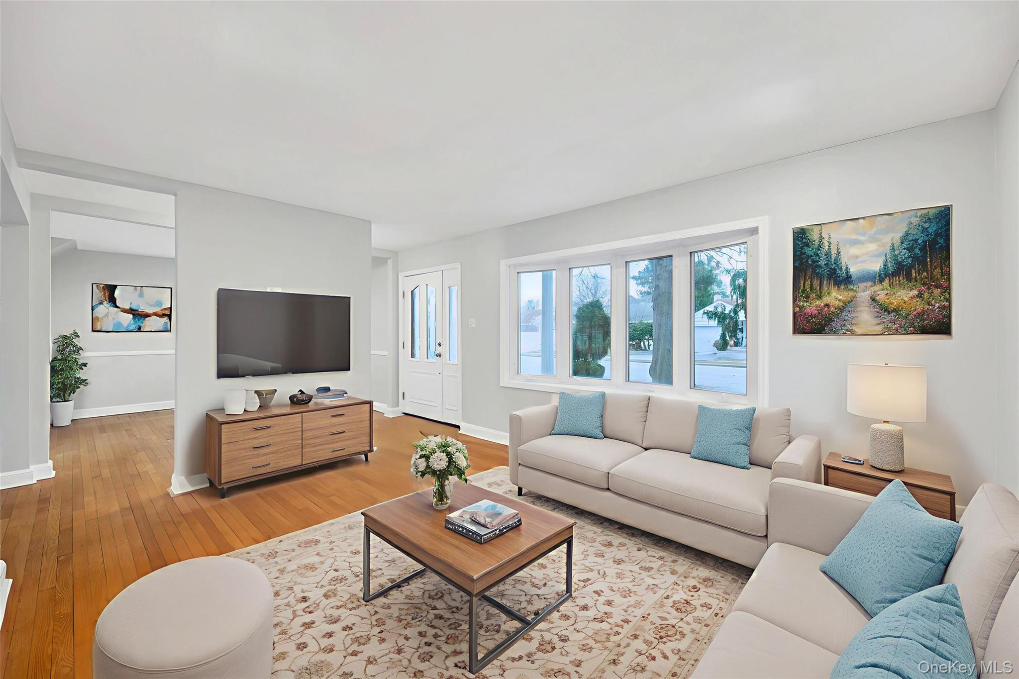 2585 Oceanside Road Oceanside, NY 11572 - Photo 2 of 30 a living room with furniture and a flat screen tv
