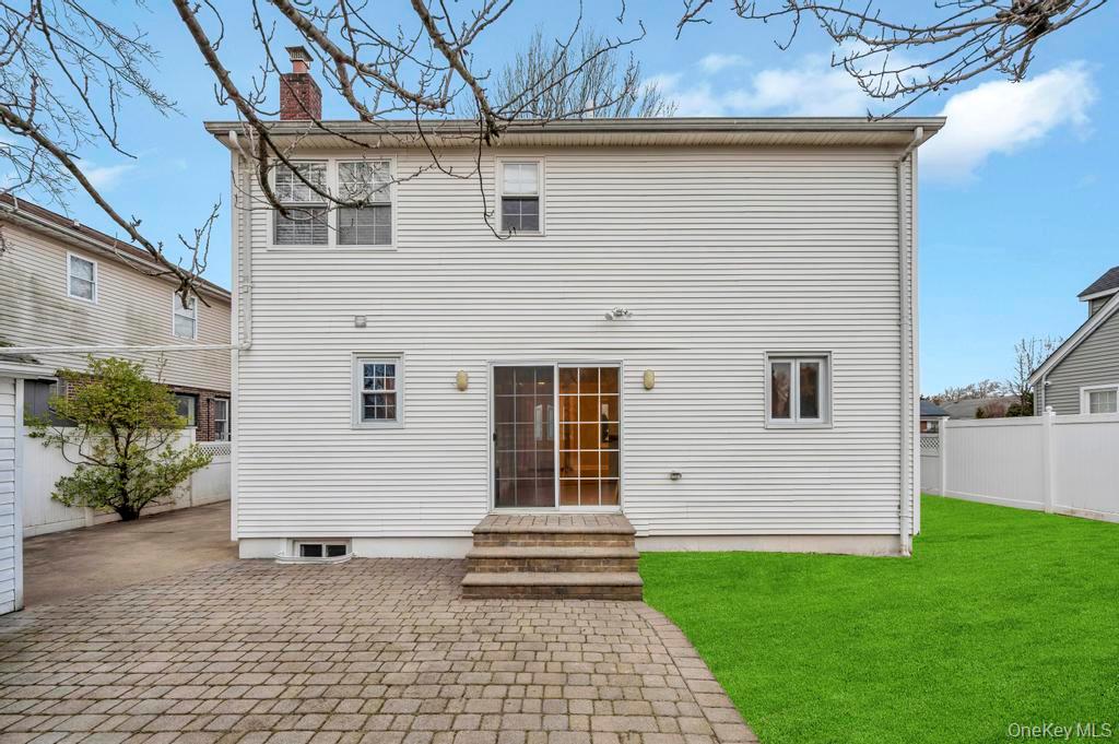 2585 Oceanside Road Oceanside, NY 11572 - Photo 23 of 30 a front view of a house with garden