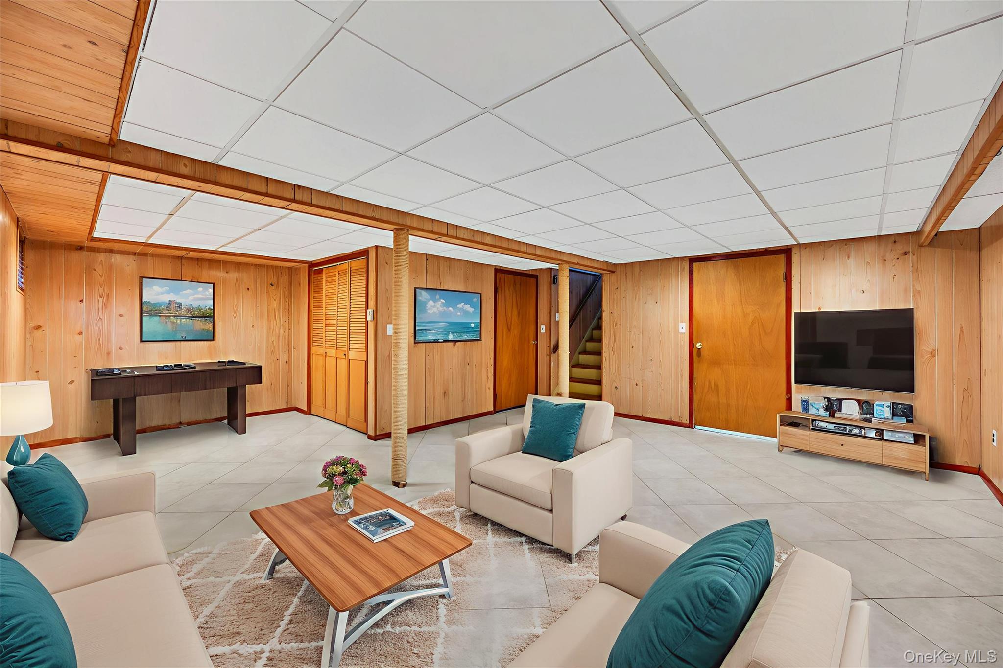 2585 Oceanside Road Oceanside, NY 11572 - Photo 27 of 30 a living room with furniture and a flat screen tv