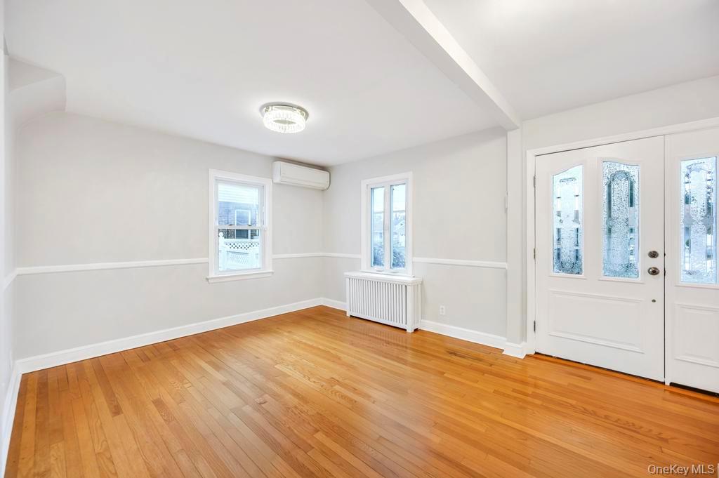 2585 Oceanside Road Oceanside, NY 11572 - Photo 5 of 30 an empty room with wooden floor and windows