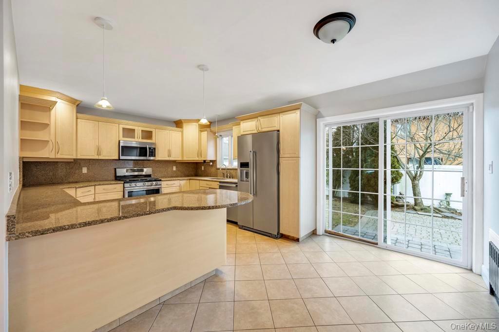 2585 Oceanside Road Oceanside, NY 11572 - Photo 6 of 30 a kitchen with stainless steel appliances granite countertop a refrigerator and a stove top oven