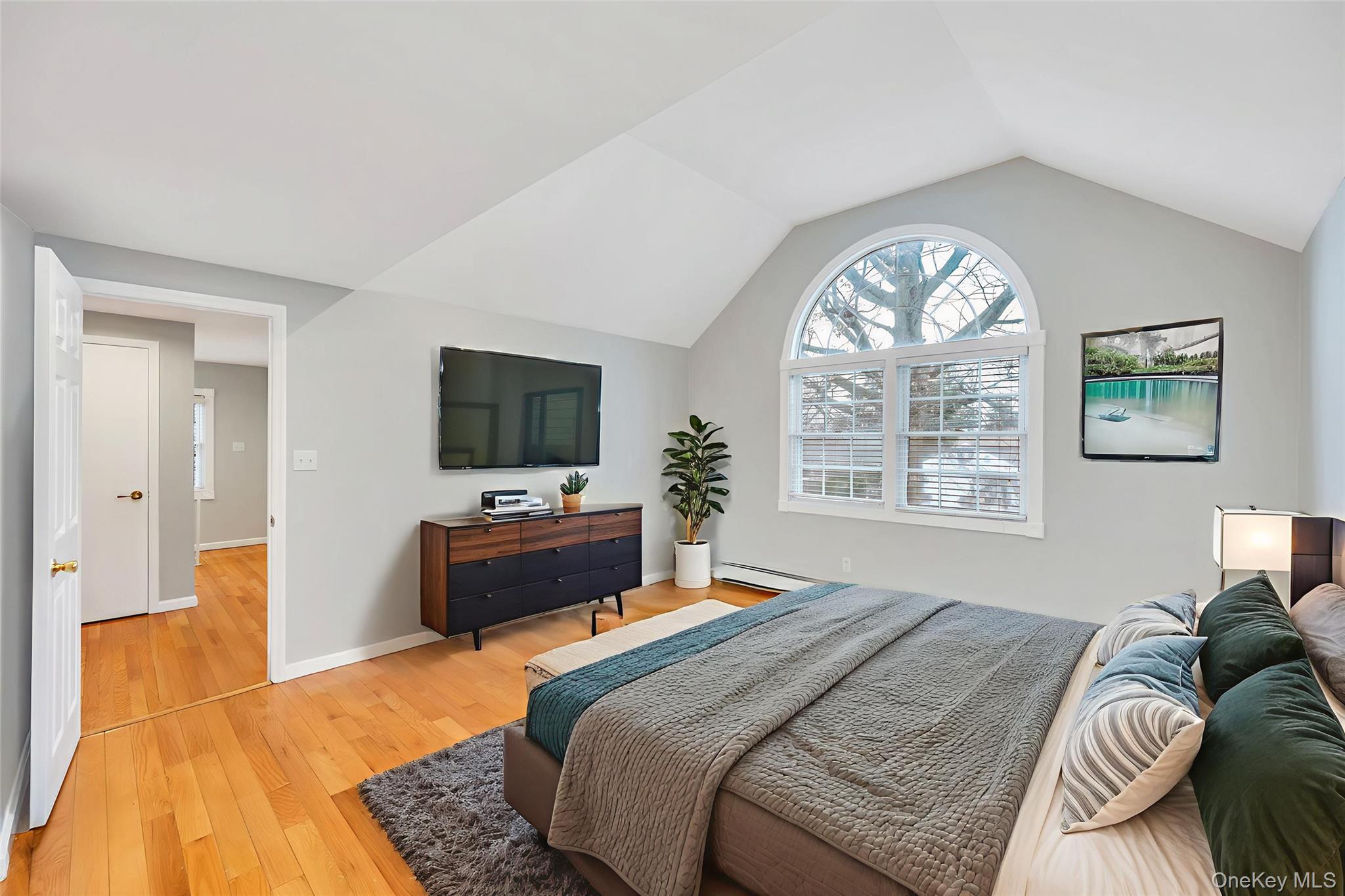 2585 Oceanside Road Oceanside, NY 11572 - Photo 10 of 30 a bedroom with a bed and a large window