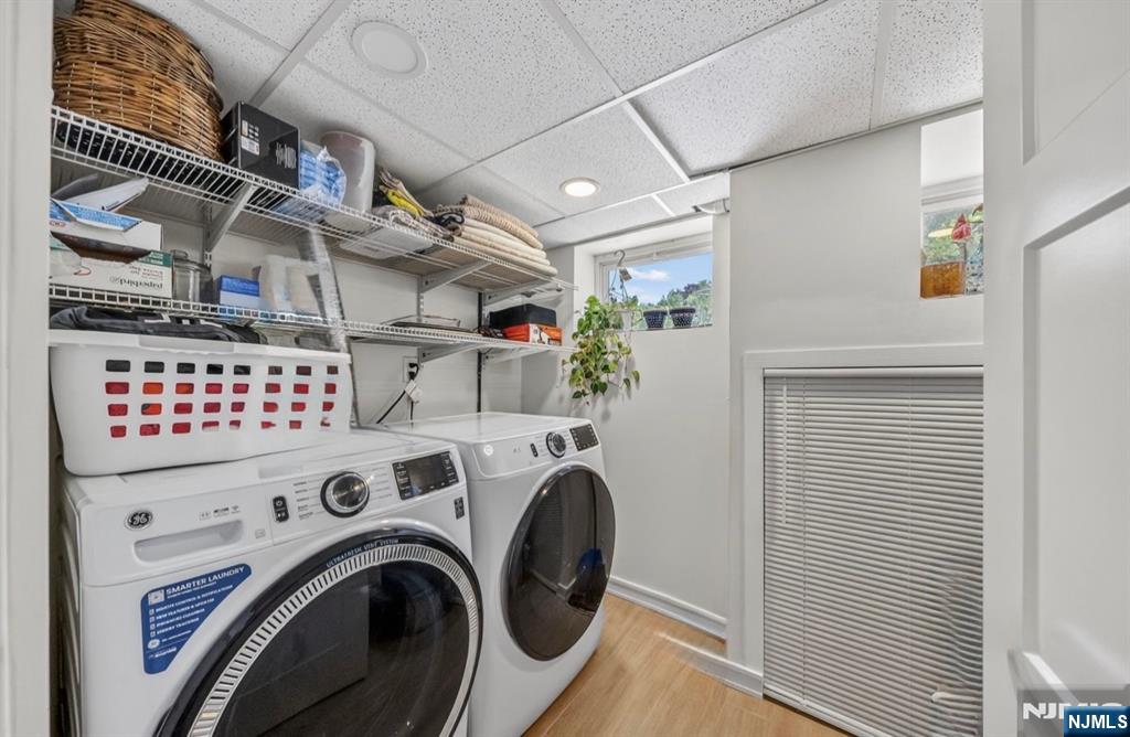 57 Hemlock Road Little Falls, NJ 07424 - Photo 29 of 50 a view of washer and dryer with kitchen in the background