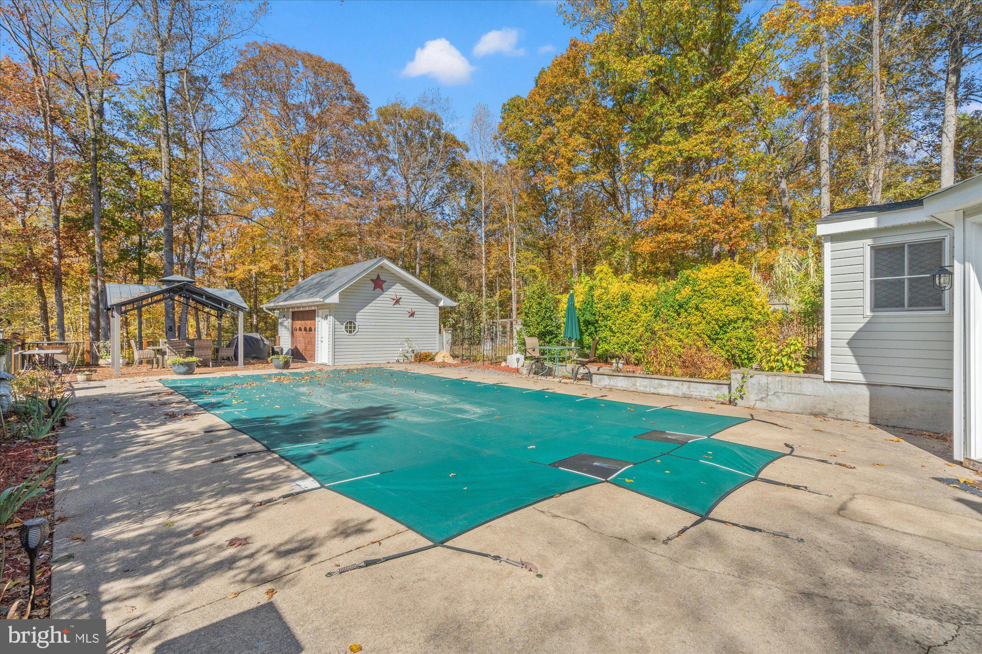 14520 Idlebrook Court Manassas, VA 20112 - Photo 24 of 87 a view of a white house next to a yard with big trees