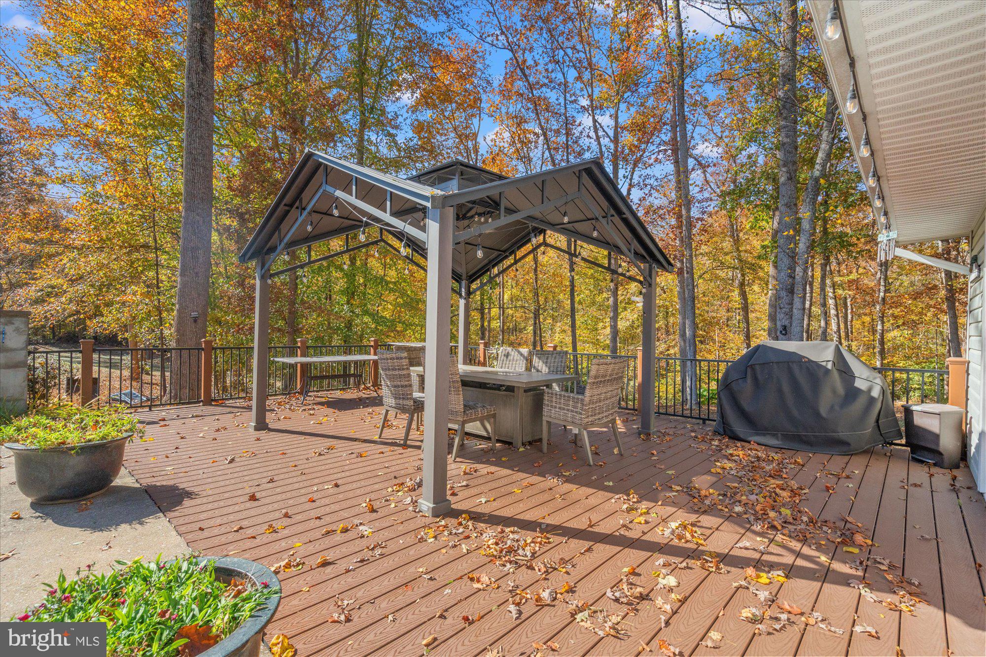 14520 Idlebrook Court Manassas, VA 20112 - Photo 32 of 87 a view of a patio with a table chairs and a potted plant