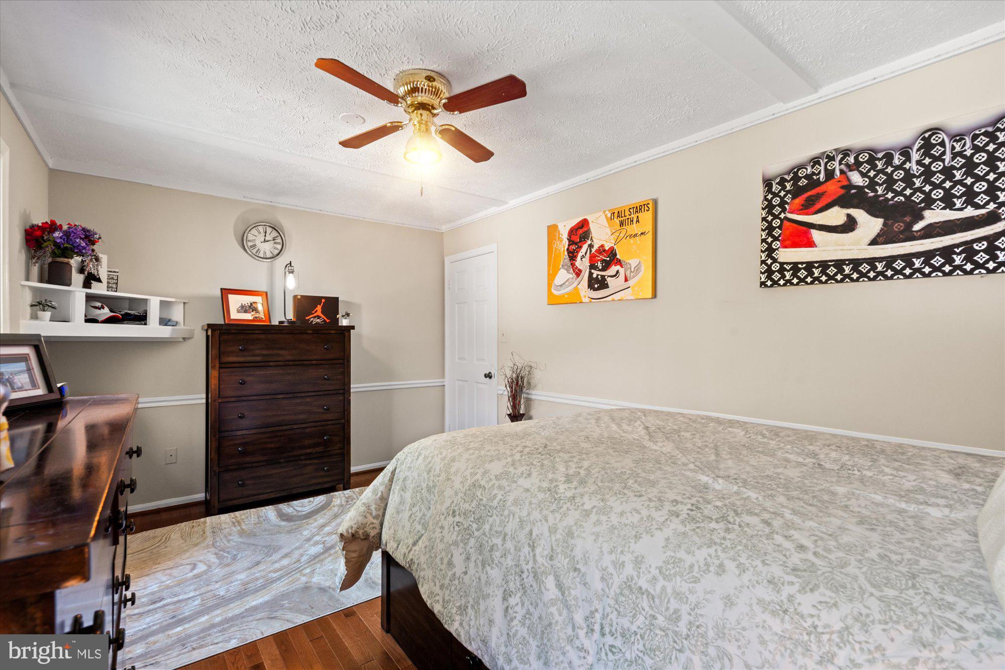 14520 Idlebrook Court Manassas, VA 20112 - Photo 39 of 87 a bedroom with a bed and a chandelier