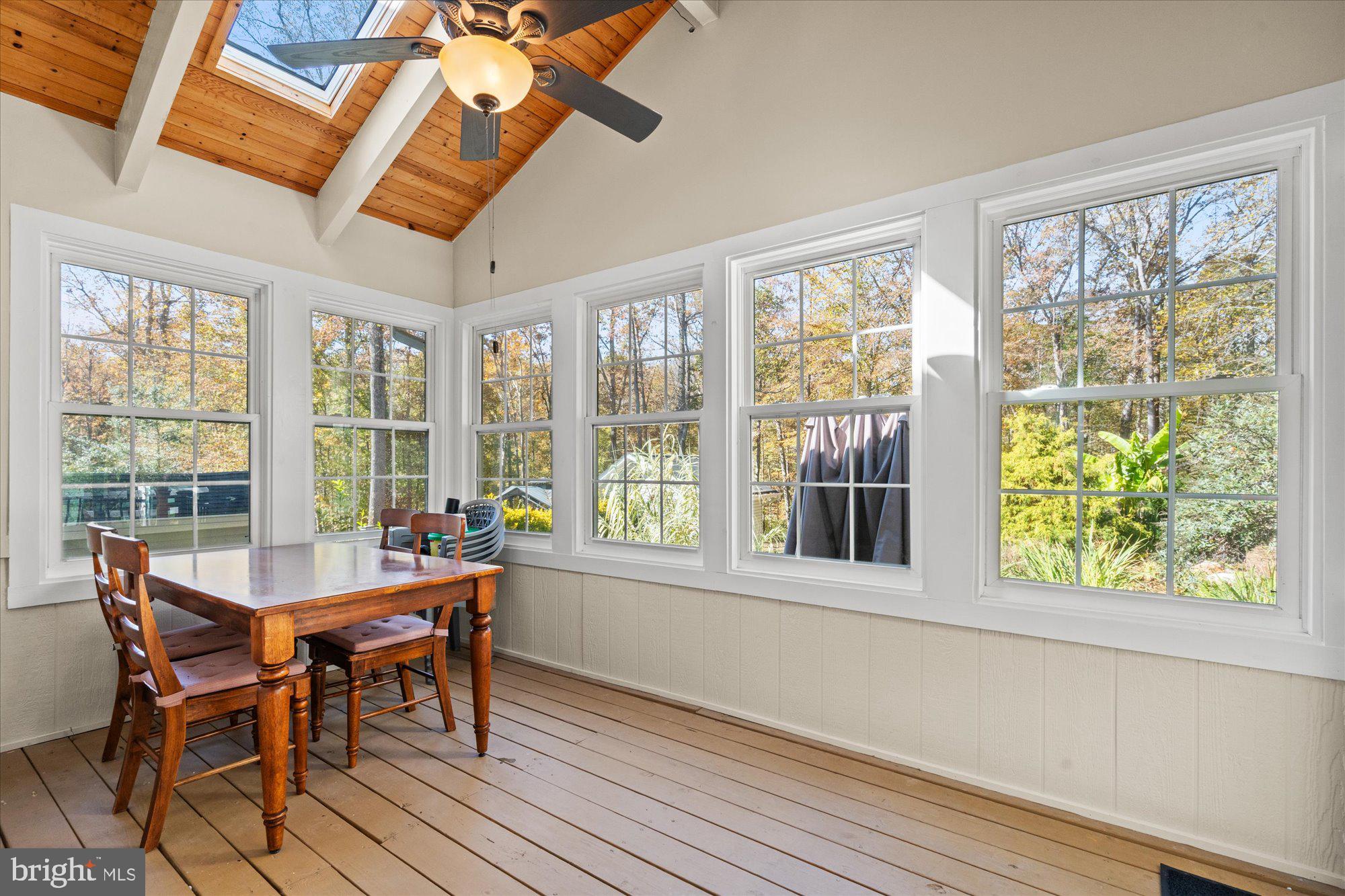 14520 Idlebrook Court Manassas, VA 20112 - Photo 50 of 87 a view of a dining room with furniture large windows and wooden floor