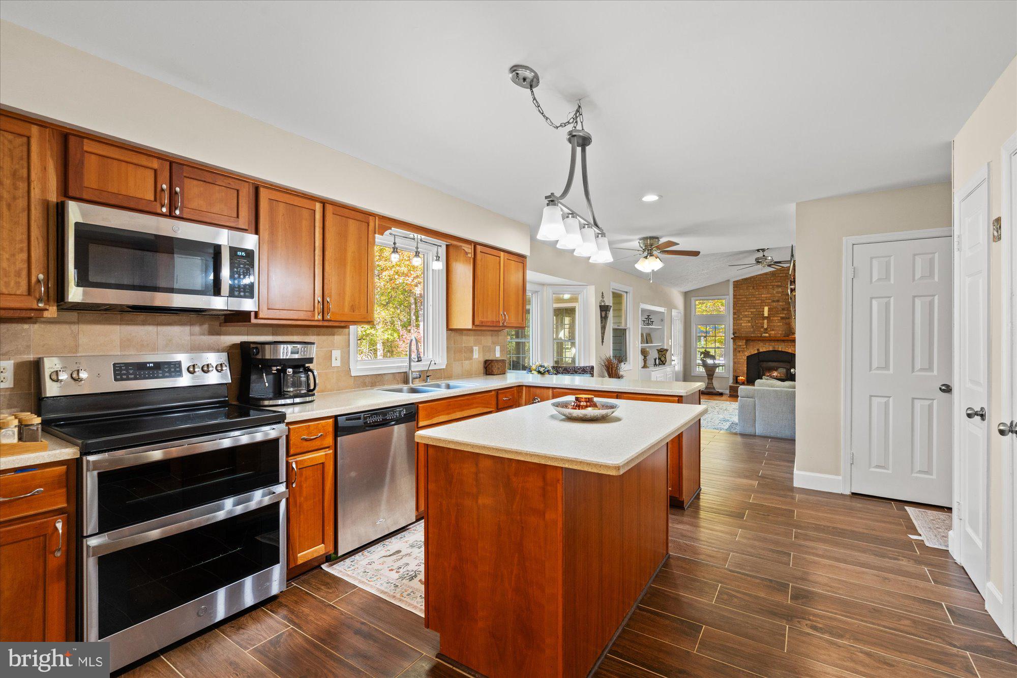 14520 Idlebrook Court Manassas, VA 20112 - Photo 57 of 87 a kitchen with stainless steel appliances granite countertop wooden cabinets a stove top oven a sink and dishwasher