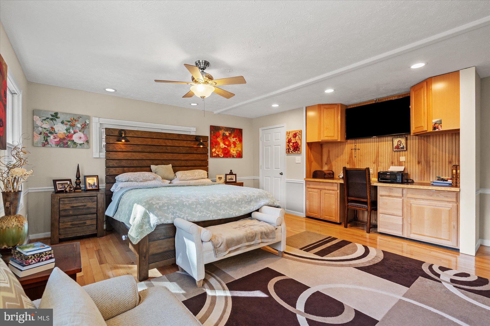 14520 Idlebrook Court Manassas, VA 20112 - Photo 59 of 87 a bedroom with a bed and wooden floor