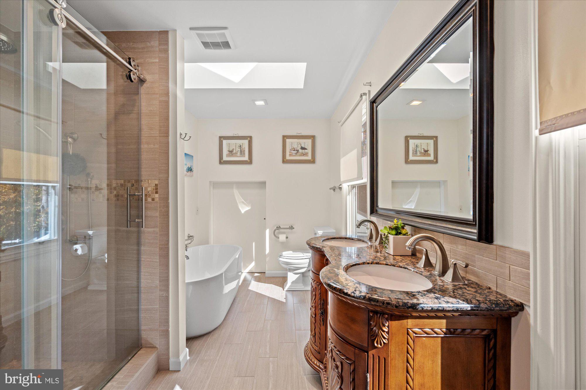 14520 Idlebrook Court Manassas, VA 20112 - Photo 76 of 87 a bathroom with a granite countertop sink and a mirror