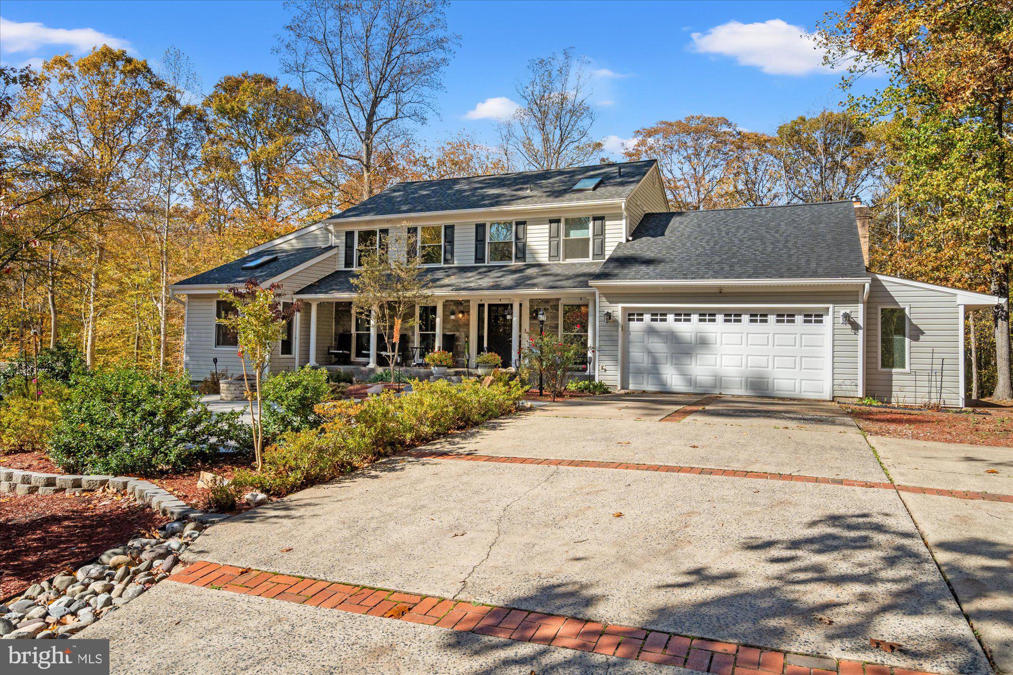 14520 Idlebrook Court Manassas, VA 20112 - Photo 80 of 87 a front view of a house with a yard and garage