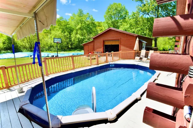 an aerial view of a house with pool yard and outdoor seating