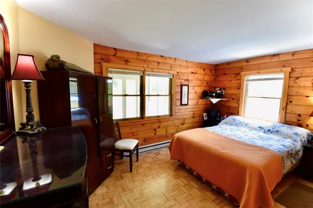a living room with furniture a chandelier and a large window