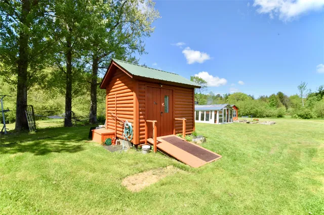 a backyard of a house with table and chairs