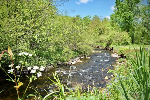 an aerial view of a house with swimming pool outdoor seating and yard