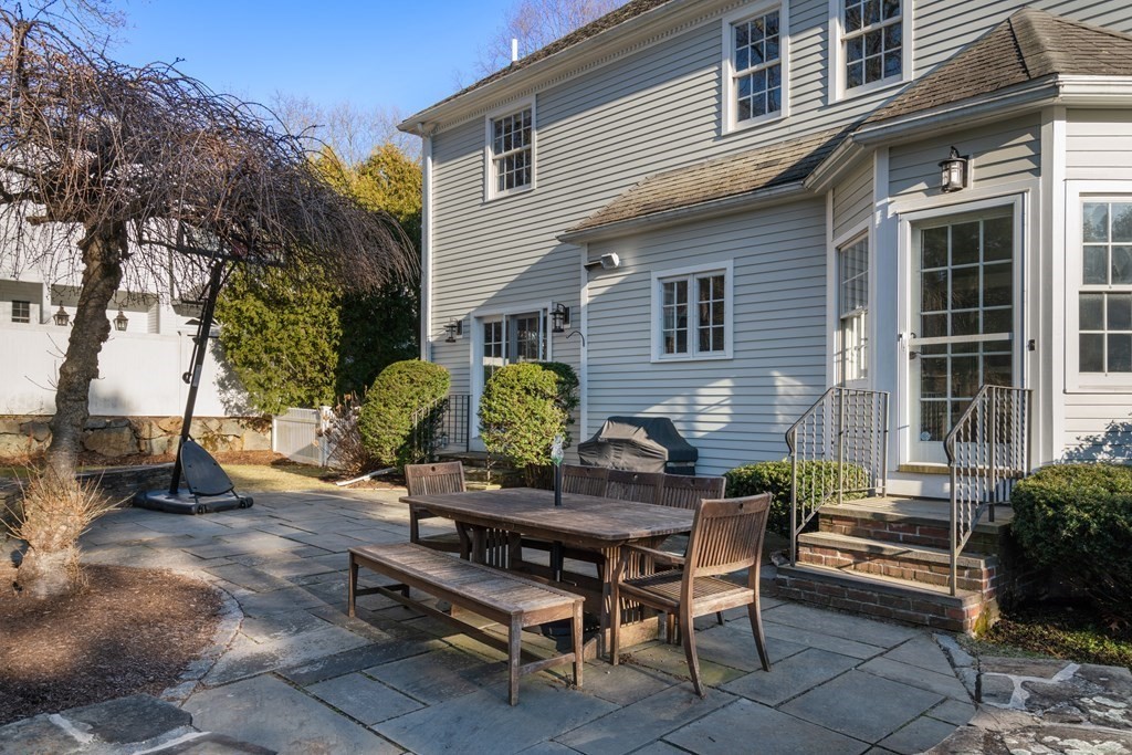 77 Monadnock Road Wellesley, MA 02481 - Photo 39 of 39 a backyard of a house with barbeque oven table and chairs