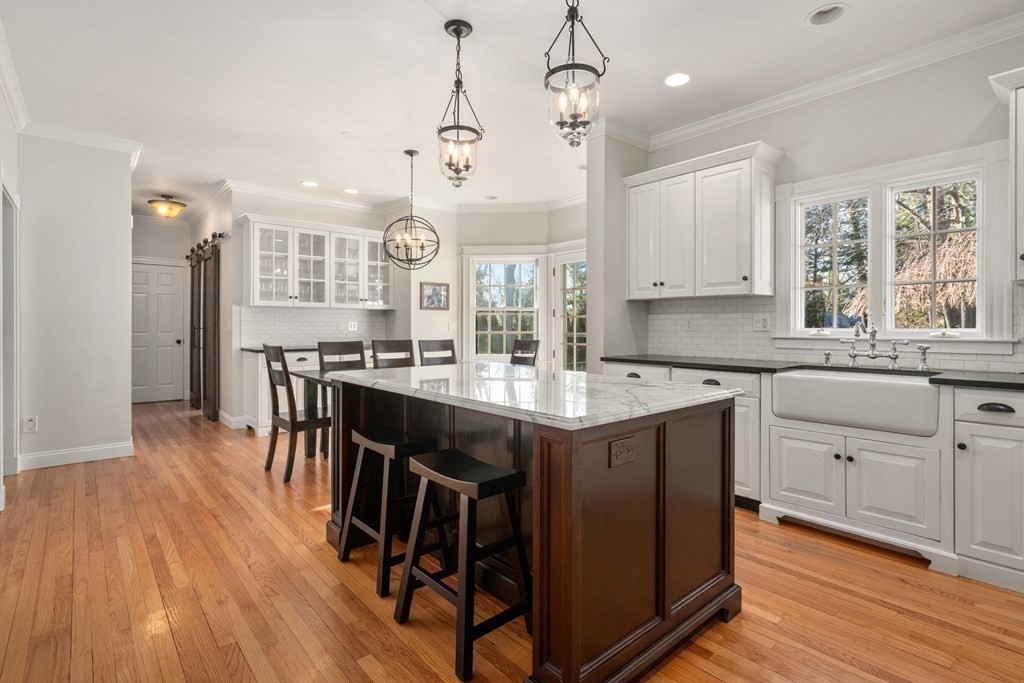 77 Monadnock Road Wellesley, MA 02481 - Photo 4 of 39 a kitchen with kitchen island granite countertop a sink a center island and cabinets