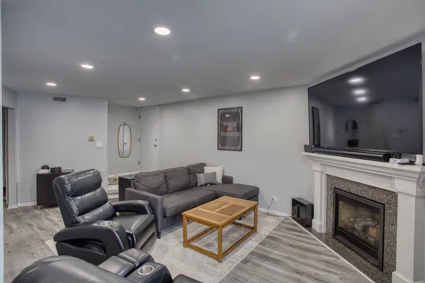 a living room with furniture and a fireplace