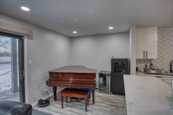 a room with furniture a piano and wooden floor
