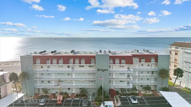 a view of a house with a small yard and potted plants