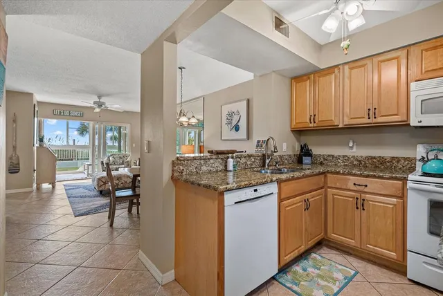 a kitchen with stainless steel appliances granite countertop a refrigerator stove and microwave