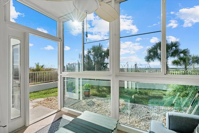 a living room with a floor to ceiling window and furniture
