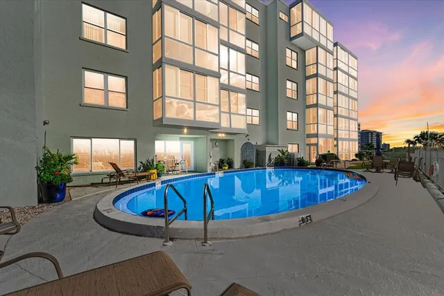 a view of a swimming pool with a lounge chairs