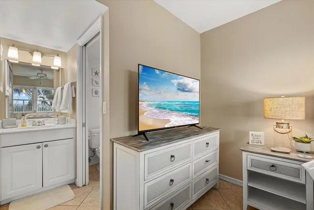a bathroom with a sink a mirror a toilet and shower