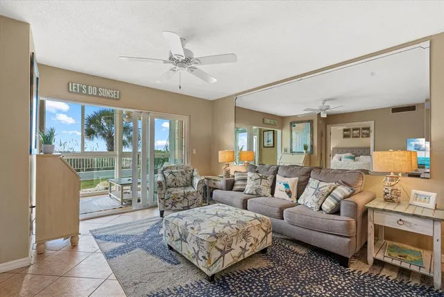 a living room with furniture and kitchen view