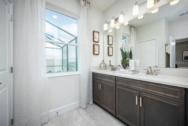 a bathroom with a double vanity sink and a mirror