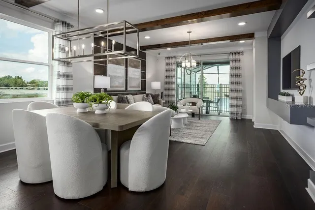 a dining room with furniture window and wooden floor
