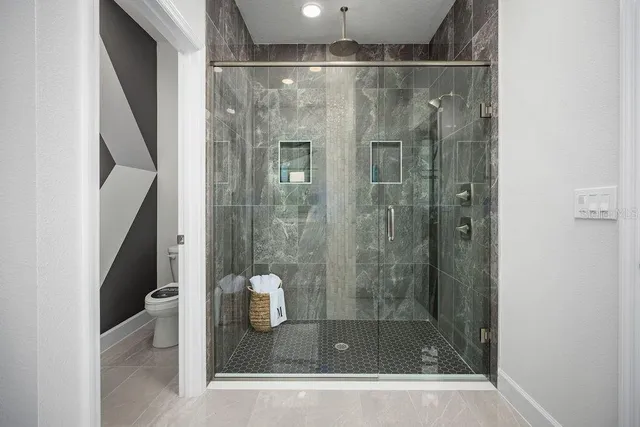a bathroom with a shower and toilet