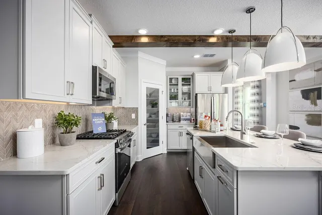 a kitchen with a sink stove and cabinets