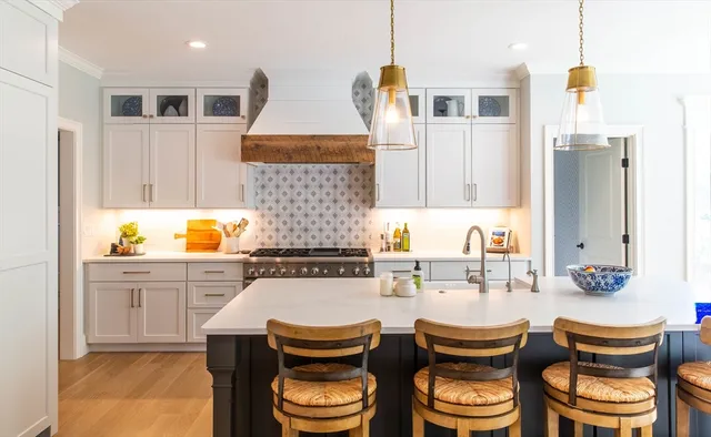 a kitchen with a table chairs sink and cabinets