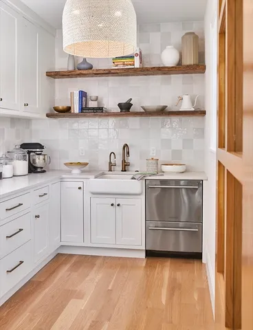 a kitchen with white cabinets and white appliances