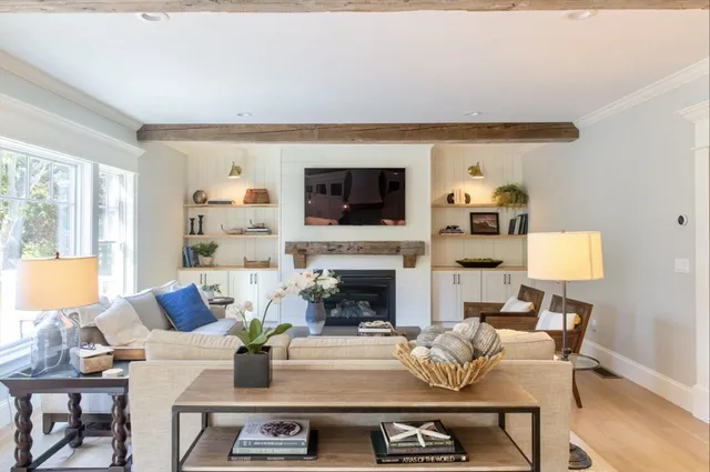a living room with furniture a flat screen tv and a fireplace