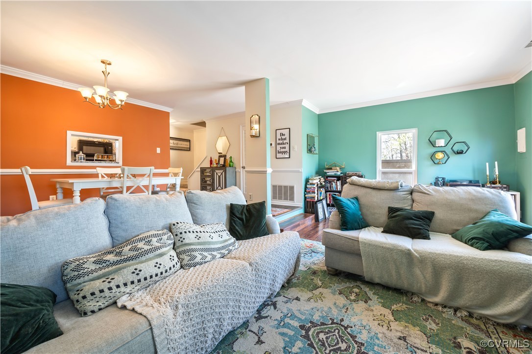 11629 East Briar Patch Drive Midlothian, VA 23113 - Photo 10 of 18 a living room with furniture and a chandelier