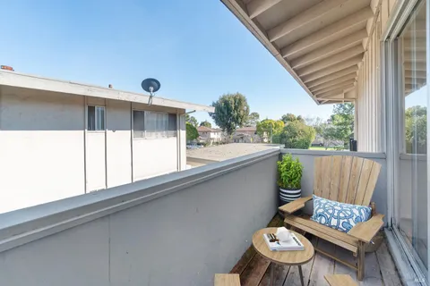 a view of balcony with furniture