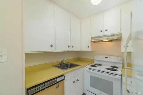 a kitchen with a sink stove and cabinets