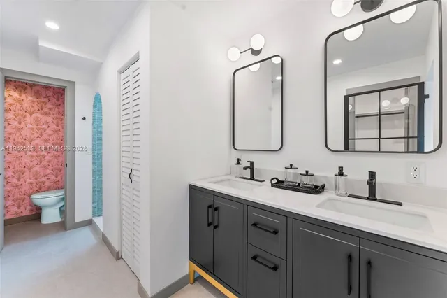 a bathroom with a double vanity sink and a mirror