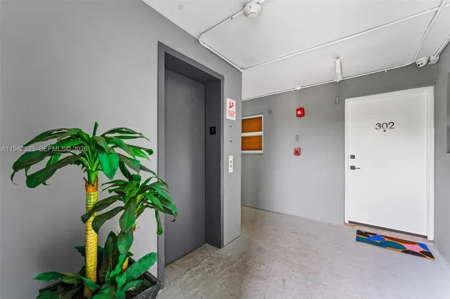 a view of entryway with window and wooden floor