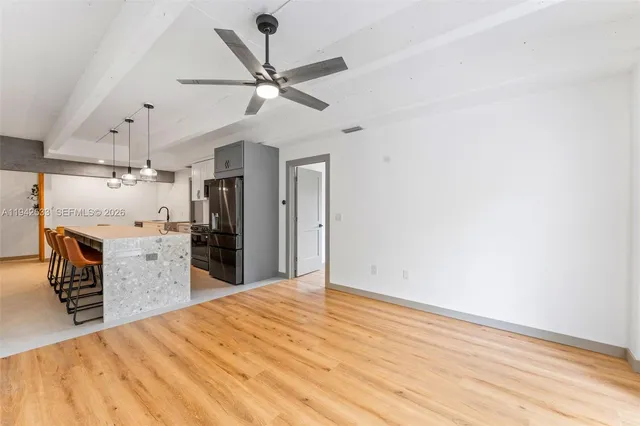 a view of a kitchen with a sink and a refrigerator
