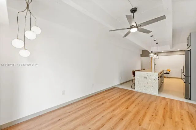 a view of a room with a dishwasher and wooden floor