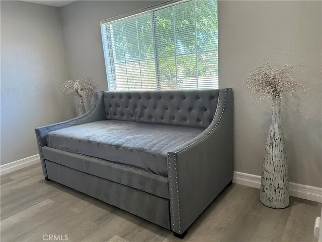 a bed sitting in a room next to a window